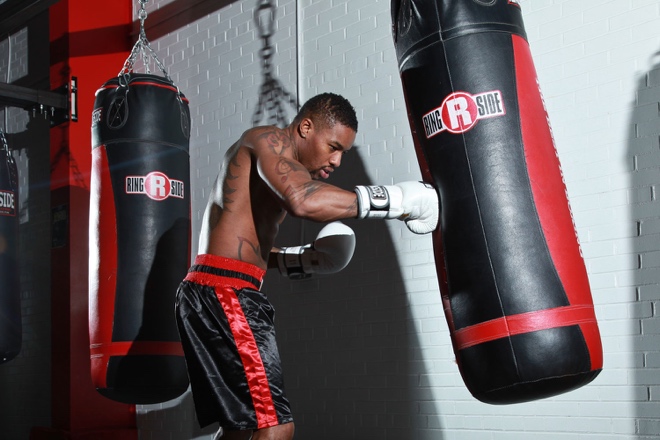 man hitting punching bag