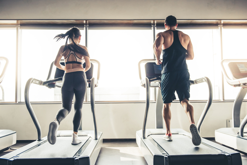 people running on a treadmill in gym