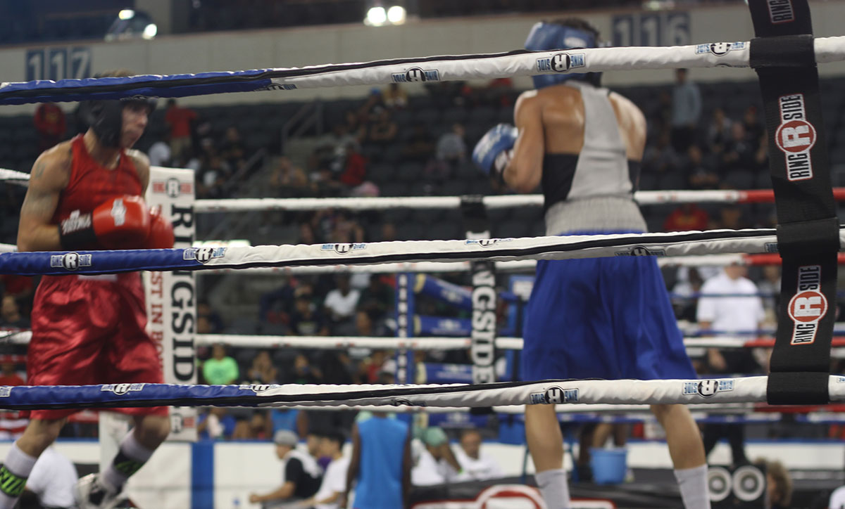 Two fighters engaged in a bout at a sanctioned boxing competition