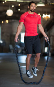 man in red shirt jumps rope