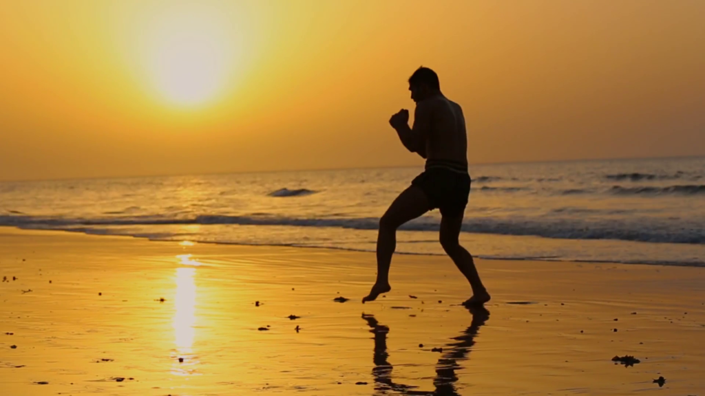 workout while traveling - shadow boxing on the beach