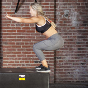 woman doing box jump to improve boxing footwork