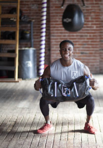 Interval training using a sand bag for weighted squats.