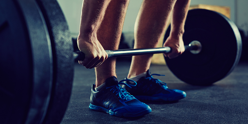 An athlete about to engage in a deadlift.