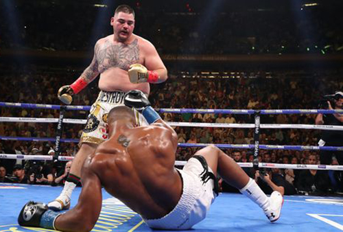 Andy Ruiz, Jr stands over Anthony Joshua as the latter is knocked down for the second time.