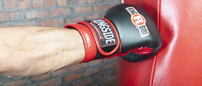 close up of punch delivered onto heavy bag