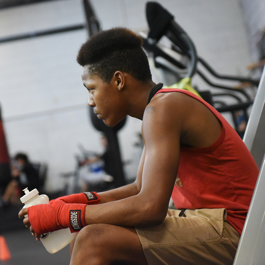A fighter sits alone in the gym.