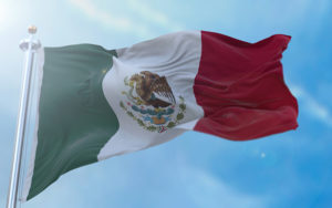 The Mexican flag waving in the wind.