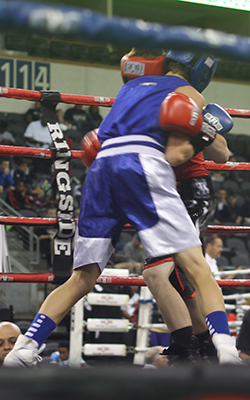 Two boxers engaged in a clinch.