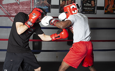 Two men spar in the boxing ring