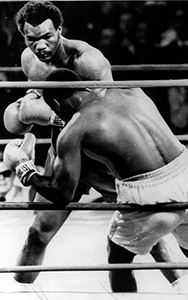 George foreman knocking Joe Frazier into the ropes in their first match.
