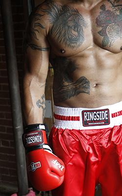 Torso and right arm of a boxer in peak physical condition.
