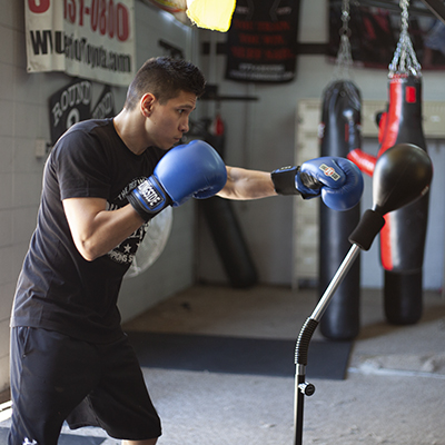 A fighter hits the cobra reflex bag with a straight jab. 